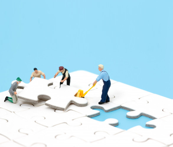 group-miniature-people-assembling-jigsaw-puzzle-business-teamwork-concept